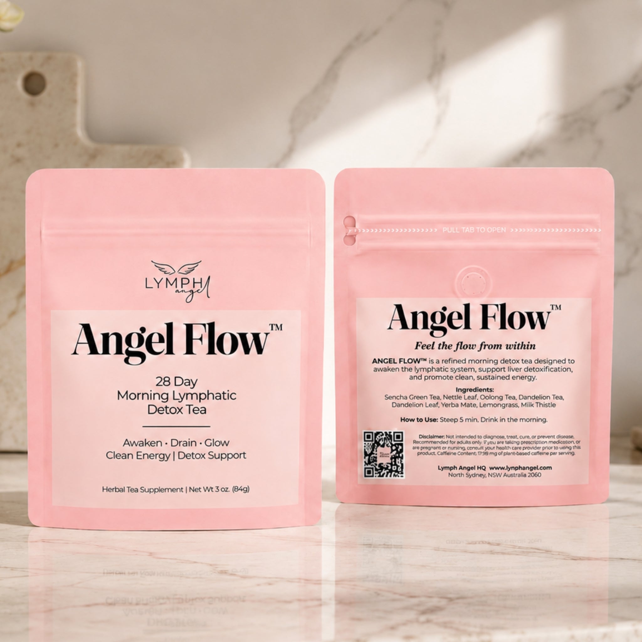 Two packages of Angel Flow tea on a marble surface